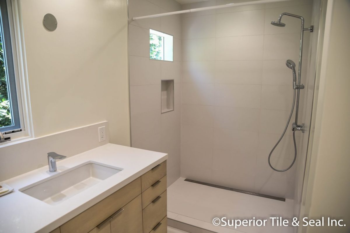 Photo of Bathroom shower tile with slab counter tops in Los Angeles